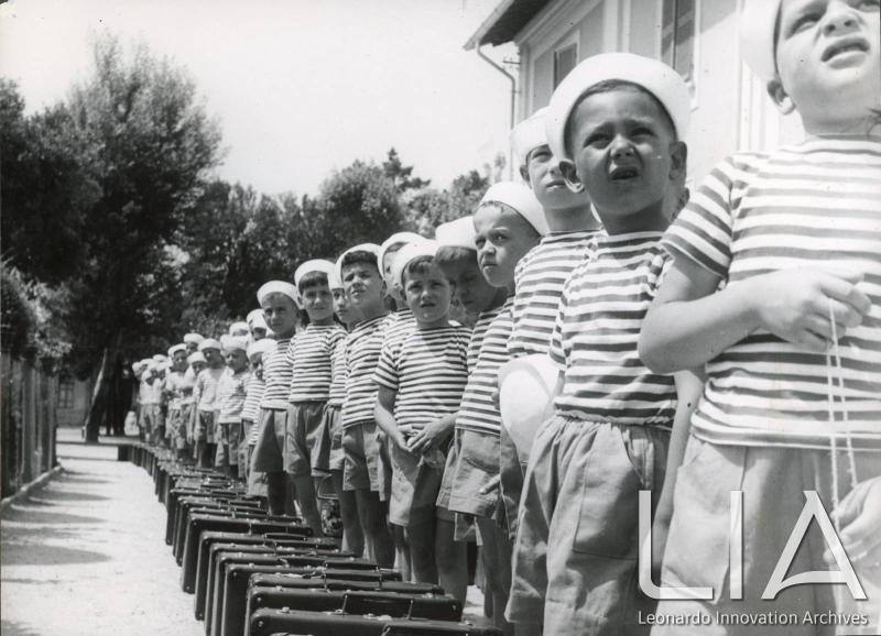 OTO - Bambini in fila con le loro valigie